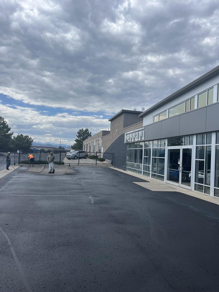 car dealership parking lot being sealcoated
