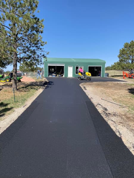 new asphalt driveway being installed