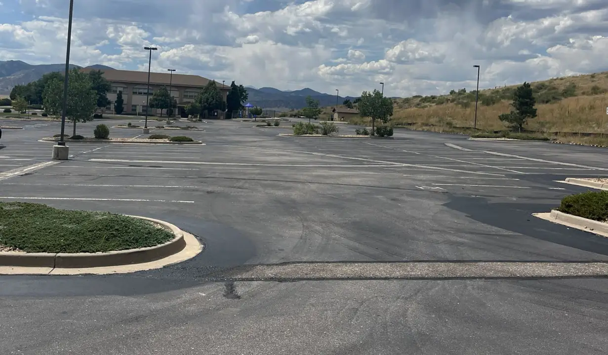 Parking lot in CO Springs which needs asphalt repair and sealcoating