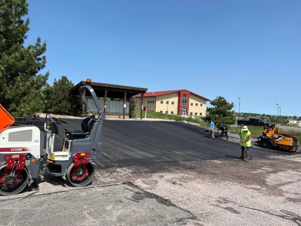 commercial parking lot with crew installing asphalt