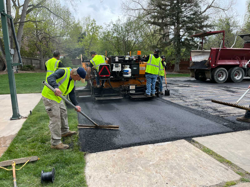 New asphalt driveway being installed