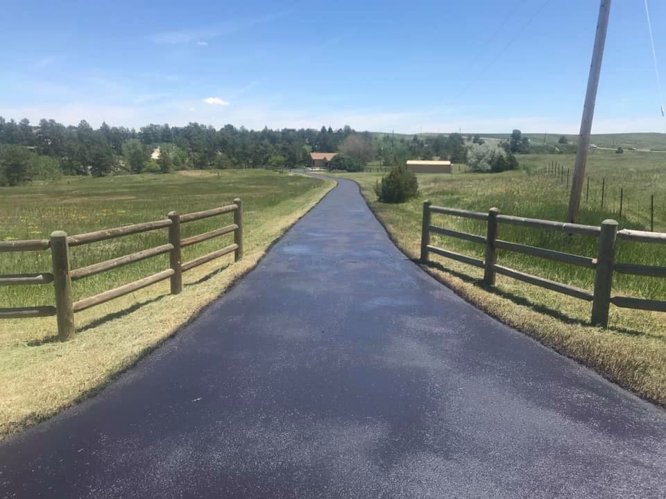 Long country driveway with wet seal coating