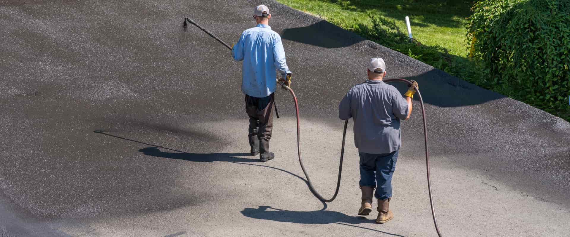 workers applying pavement coating