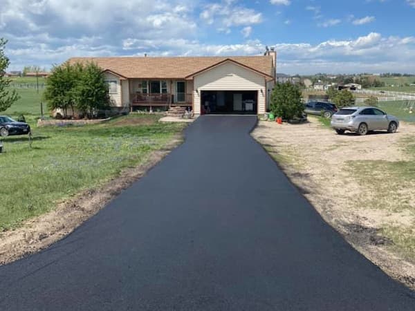 Country home with a new asphalt driveway